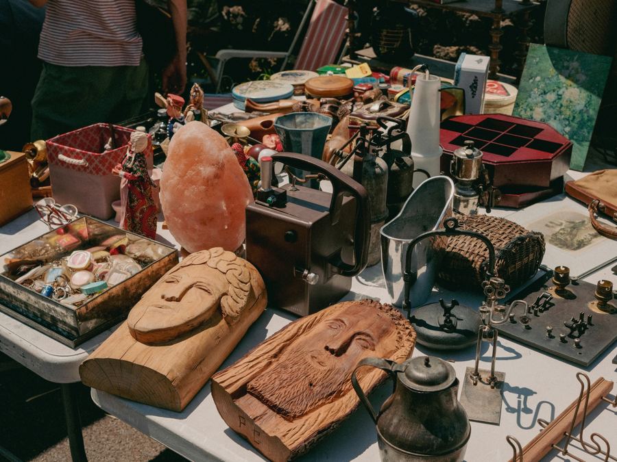 Tables of antiques and collectibles on display during a staffed two-day estate sale Tables of antiques and collectibles on display during a staffed two-day estate sale
